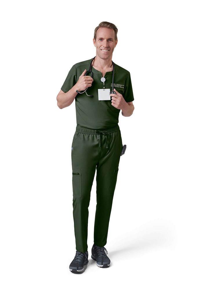 Man wearing MedTailor men's custom scrub top in Highland Green color fabric