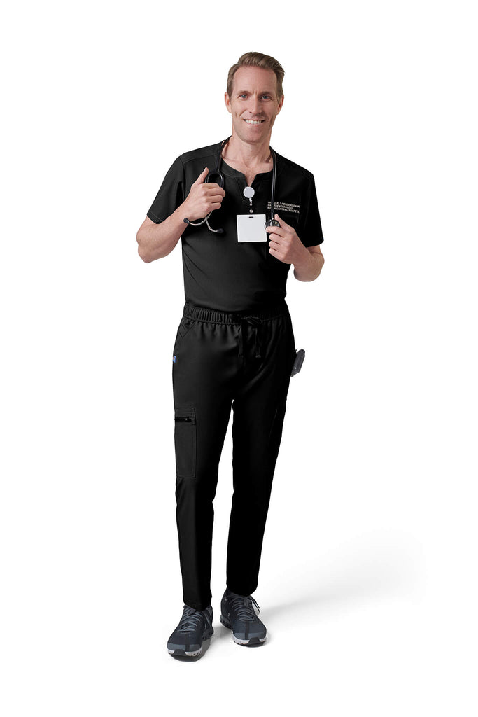Man wearing MedTailor men's custom scrub top in Jet Black color fabric