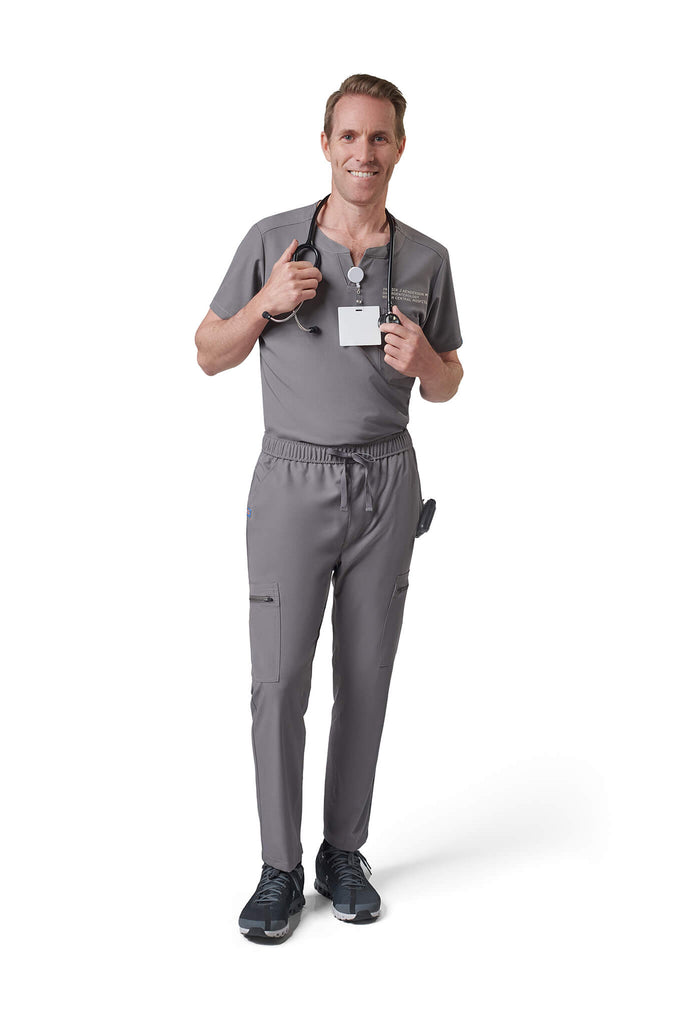 Man wearing MedTailor men's custom scrub top in Platinum Gray color fabric