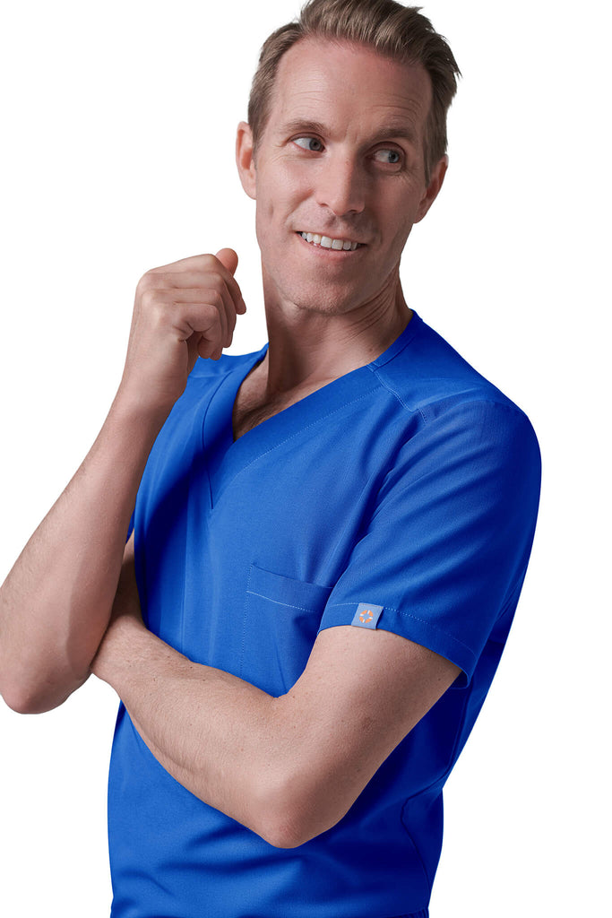 Man wearing MedTailor men's scrub top in Royal Blue color fabric