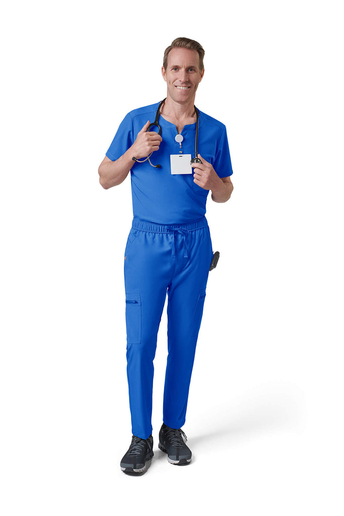 Man wearing MedTailor men's scrub top in Royal Blue color fabric