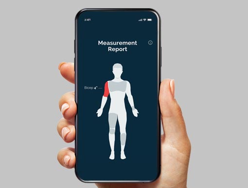 A woman's hand holding a mobile phone displaying MedTailor's measurement report. The image shows the areas of the human body that is measured.