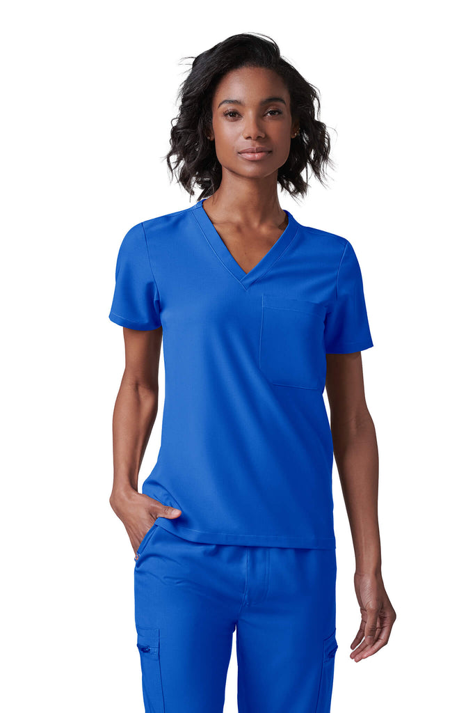 Woman wearing MedTailor women's scrub top in Royal Blue color fabric