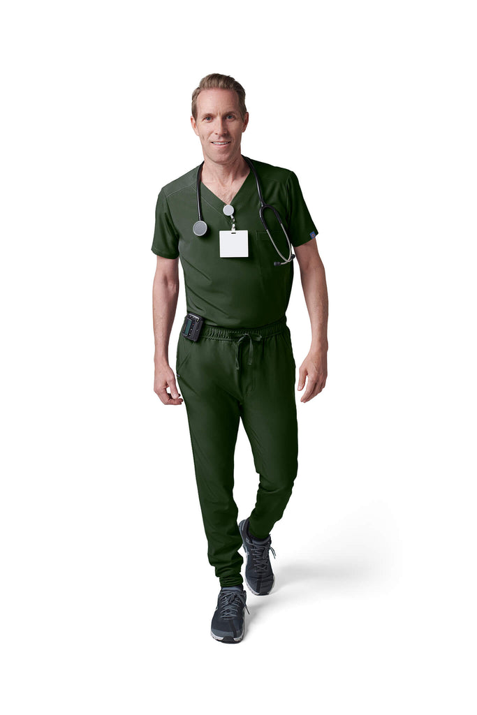 Man wearing MedTailor men's custom scrub pants in Highland Green color fabric