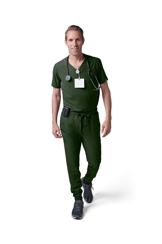 Man wearing MedTailor men's scrub pants in Highland Green color fabric