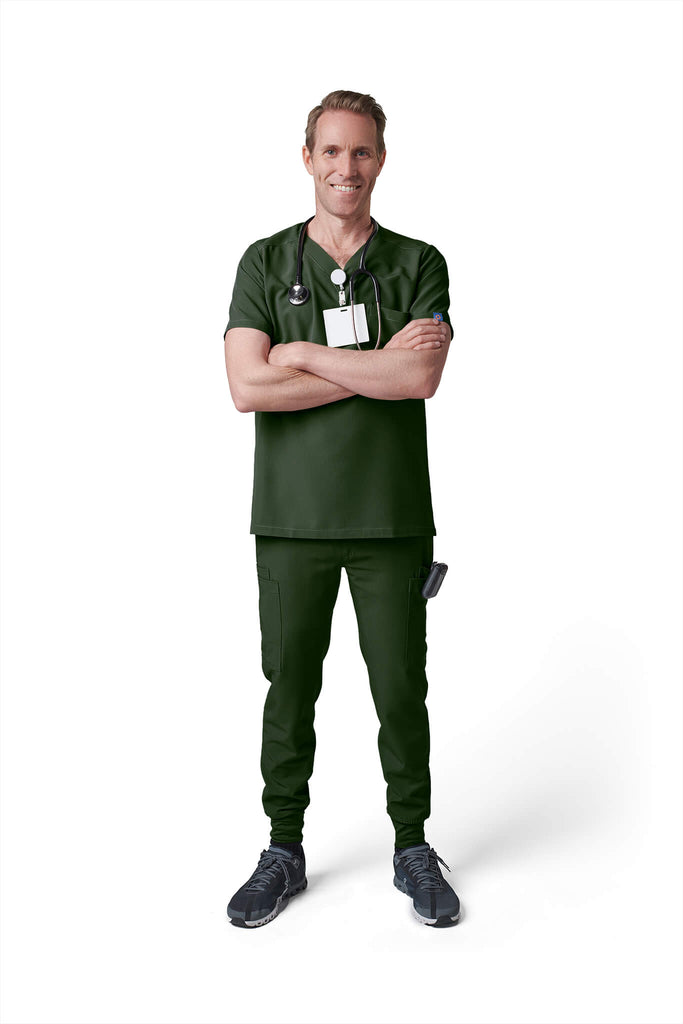 Man wearing MedTailor men's custom scrub pants in Highland Green color fabric