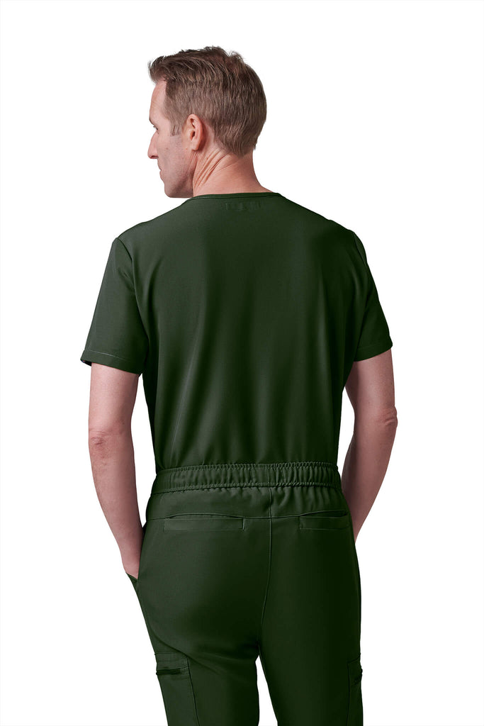Man wearing MedTailor men's custom scrub pants in Highland Green color fabric