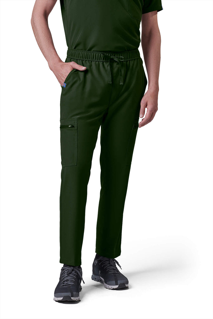 Man wearing MedTailor men's custom scrub pants in Highland Green color fabric
