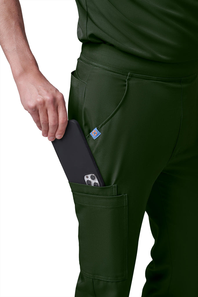 Man wearing MedTailor men's custom scrub pants in Highland Green color fabric