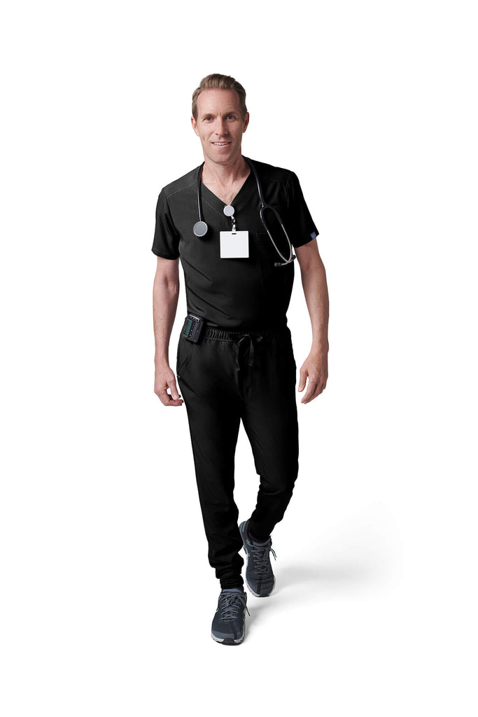 Man wearing MedTailor men's custom scrub pants in Jet Black color fabric