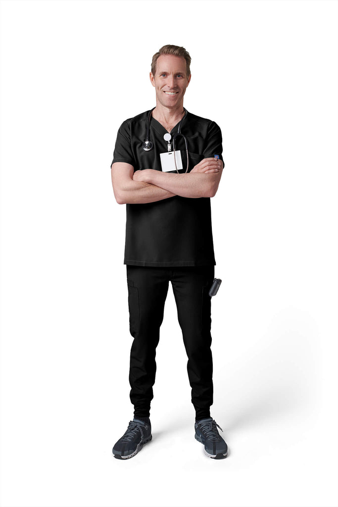 Man wearing MedTailor men's scrub custom pants in Jet Black color fabric