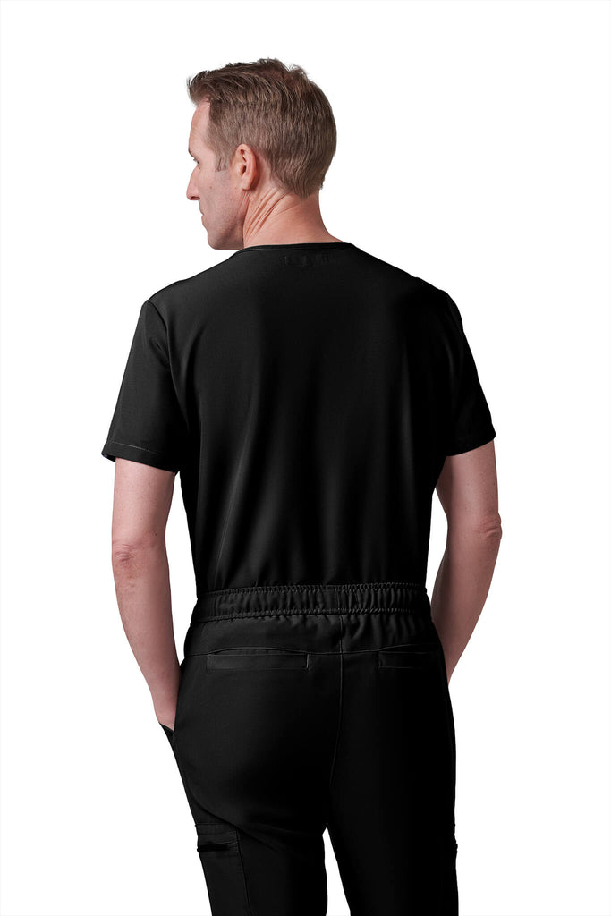 Man wearing MedTailor men's custom scrub pants in Jet Black color fabric