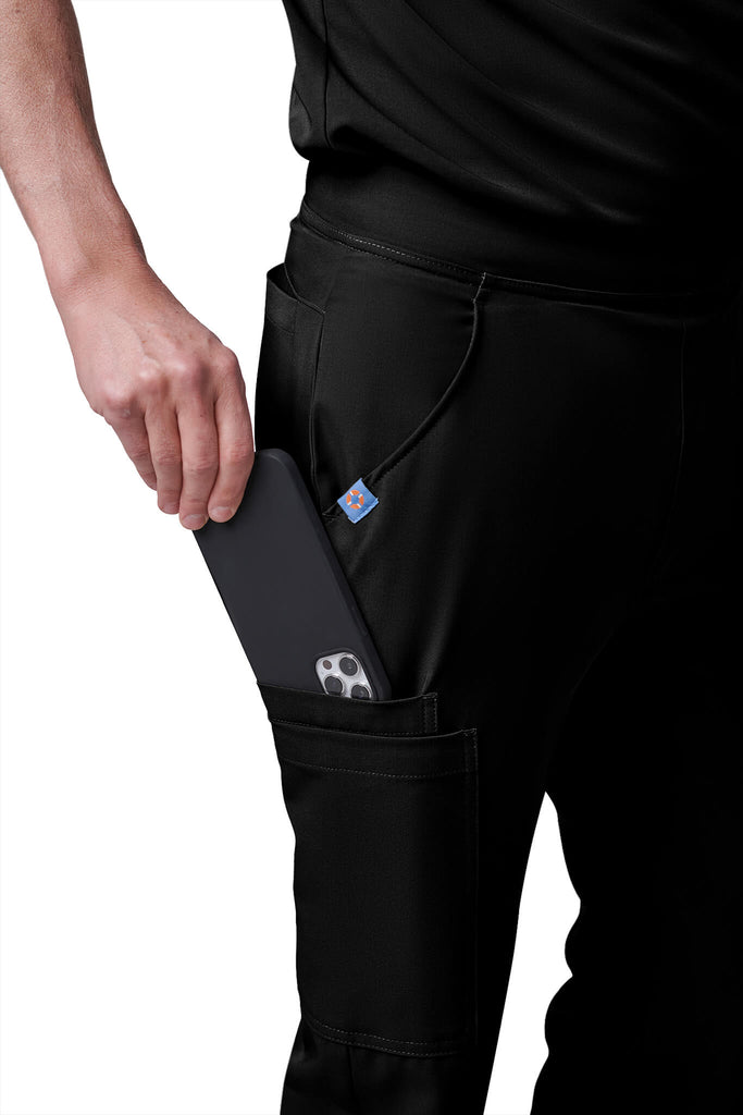 Man wearing MedTailor men's custom scrub pants in Jet Black color fabric