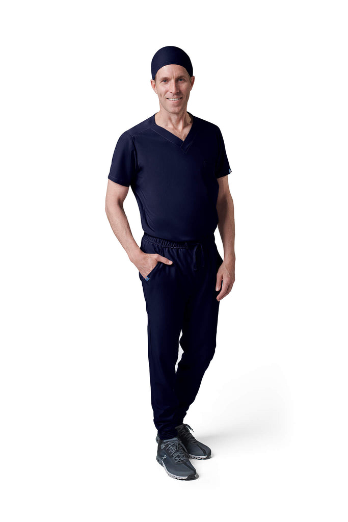 Man wearing MedTailor men's custom scrub cap in Navy Blue color fabric