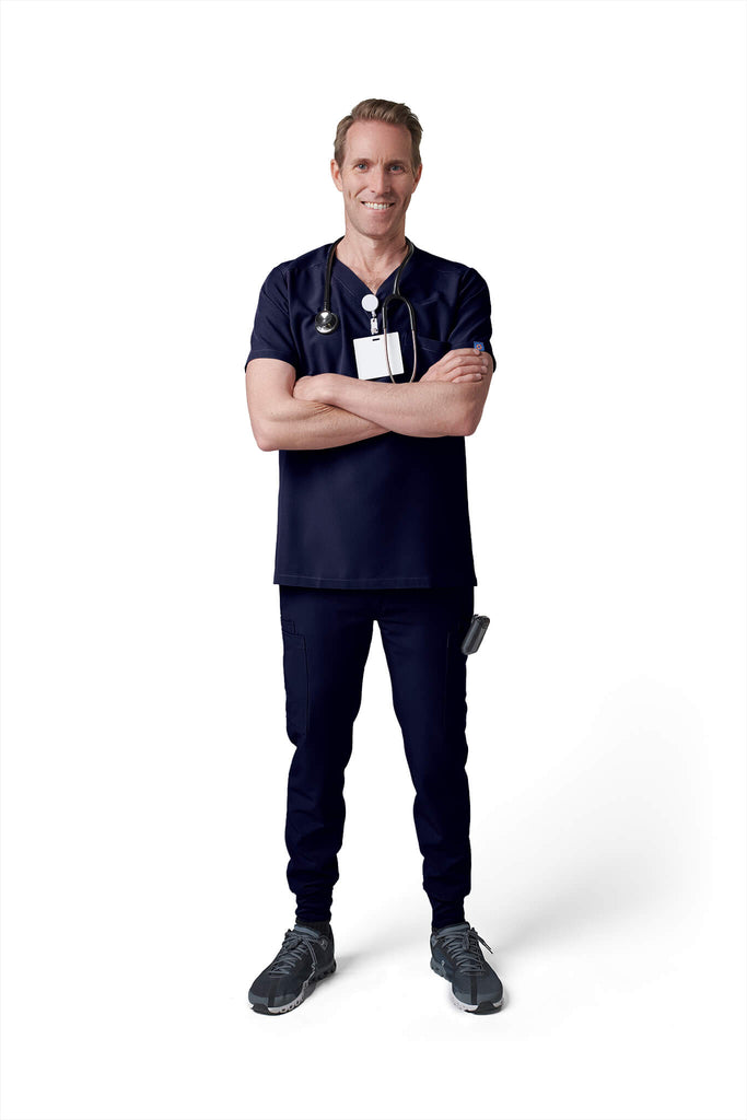 Man wearing MedTailor men's custom scrub pants in Navy Blue color fabric