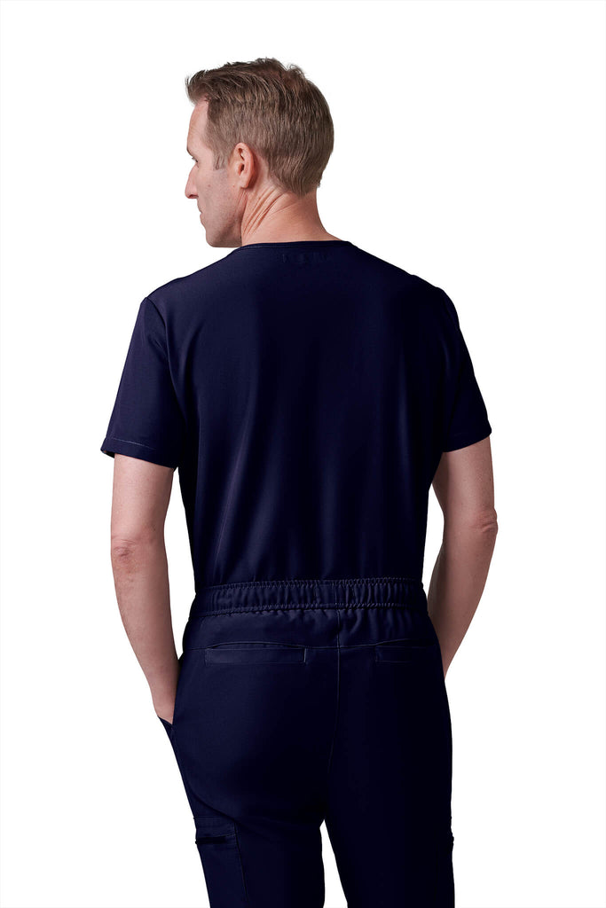 Man wearing MedTailor men's custom scrub pants in Navy Blue color fabric