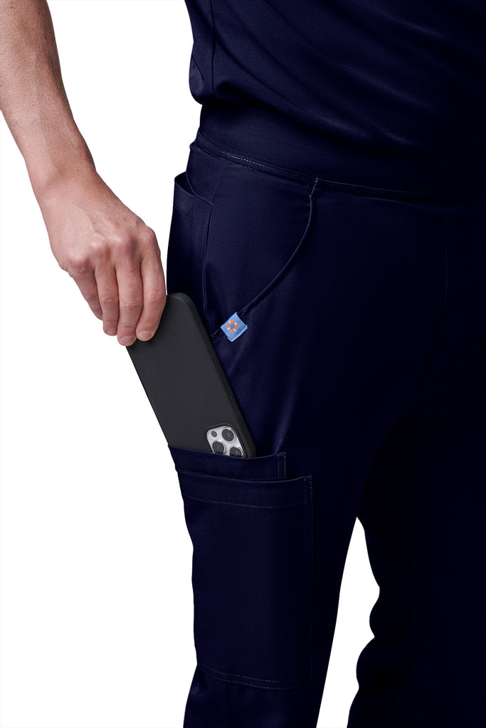 Man wearing MedTailor men's custom scrub pants in Navy Blue color fabric