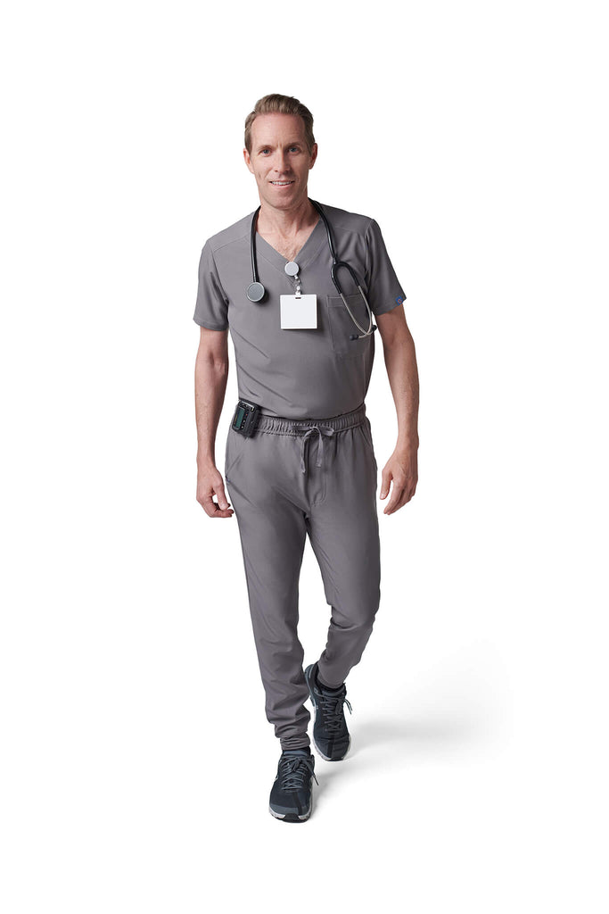 Man wearing MedTailor men's custom scrub pants in Platinum Gray color fabric