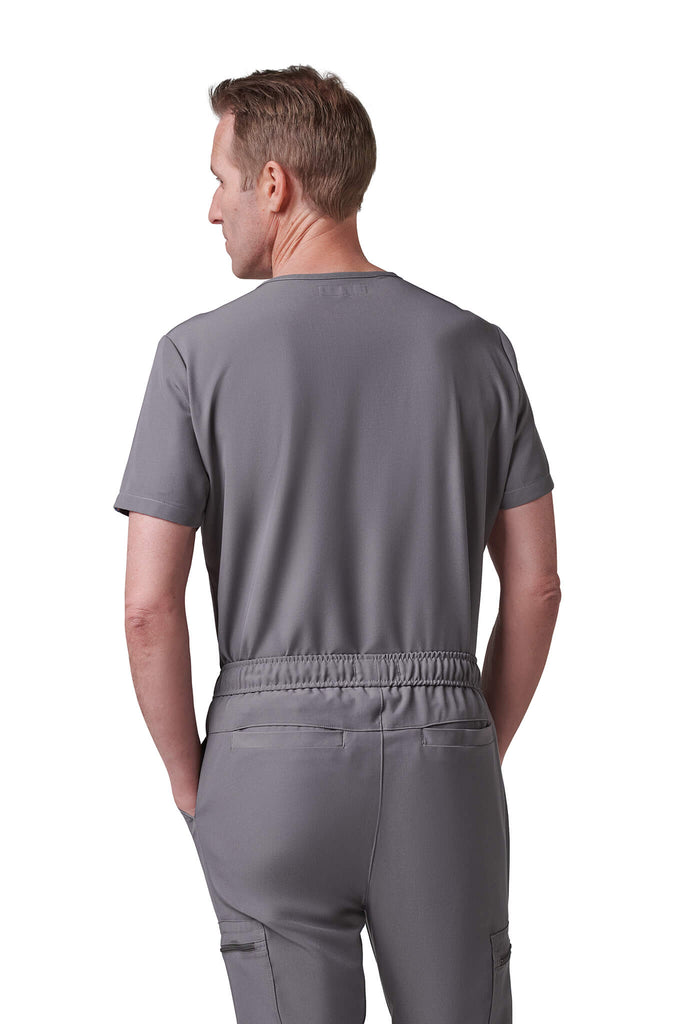 Man wearing MedTailor men's custom scrub pants in Platinum Gray color fabric