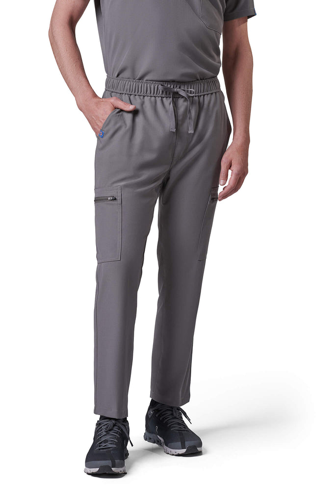 Man wearing MedTailor men's custom scrub pants in Platinum Gray color fabric