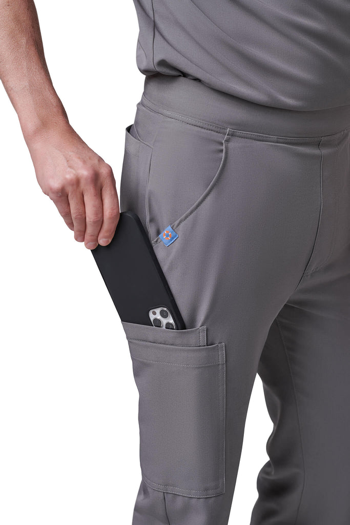 Man wearing MedTailor men's custom scrub pants in Platinum Gray color fabric