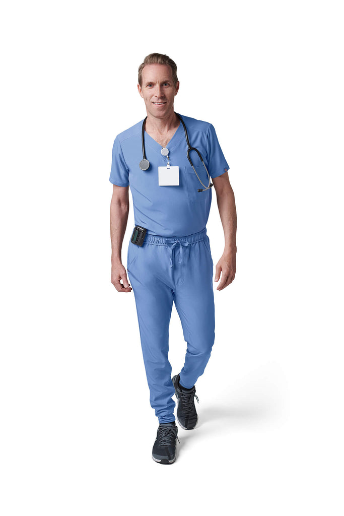 Man wearing MedTailor men's custom scrub pants in Sky Blue color fabric