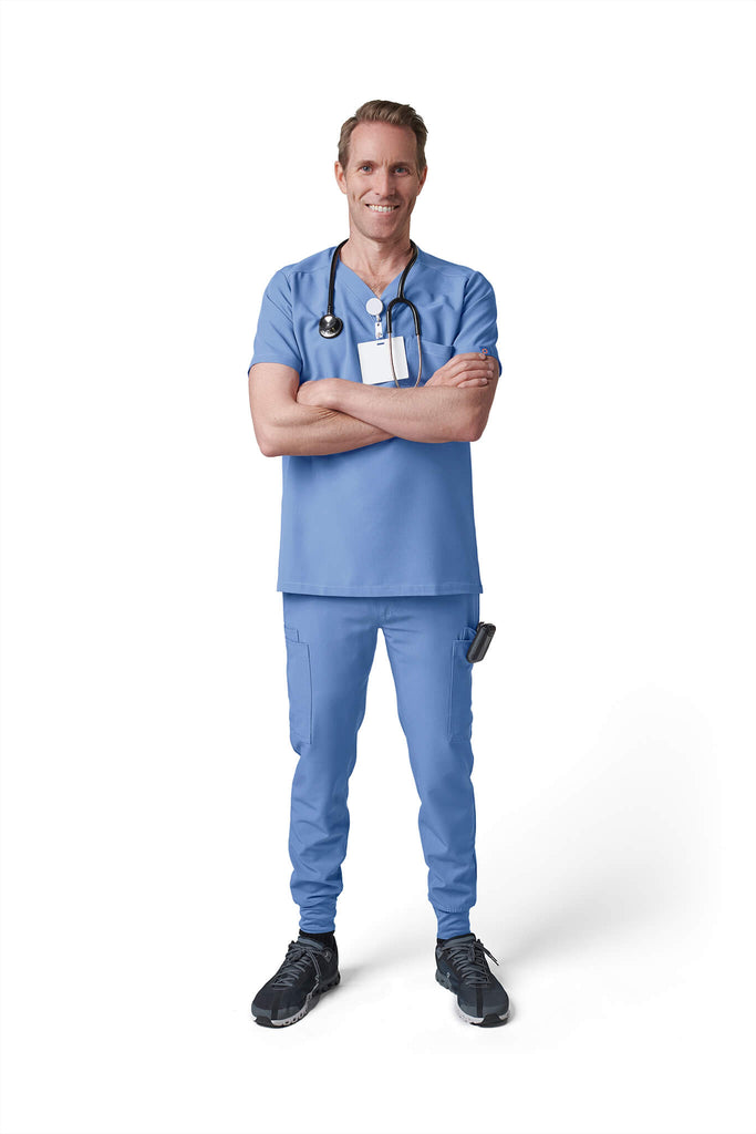 Man wearing MedTailor men's custom scrub pants in Sky Blue color fabric
