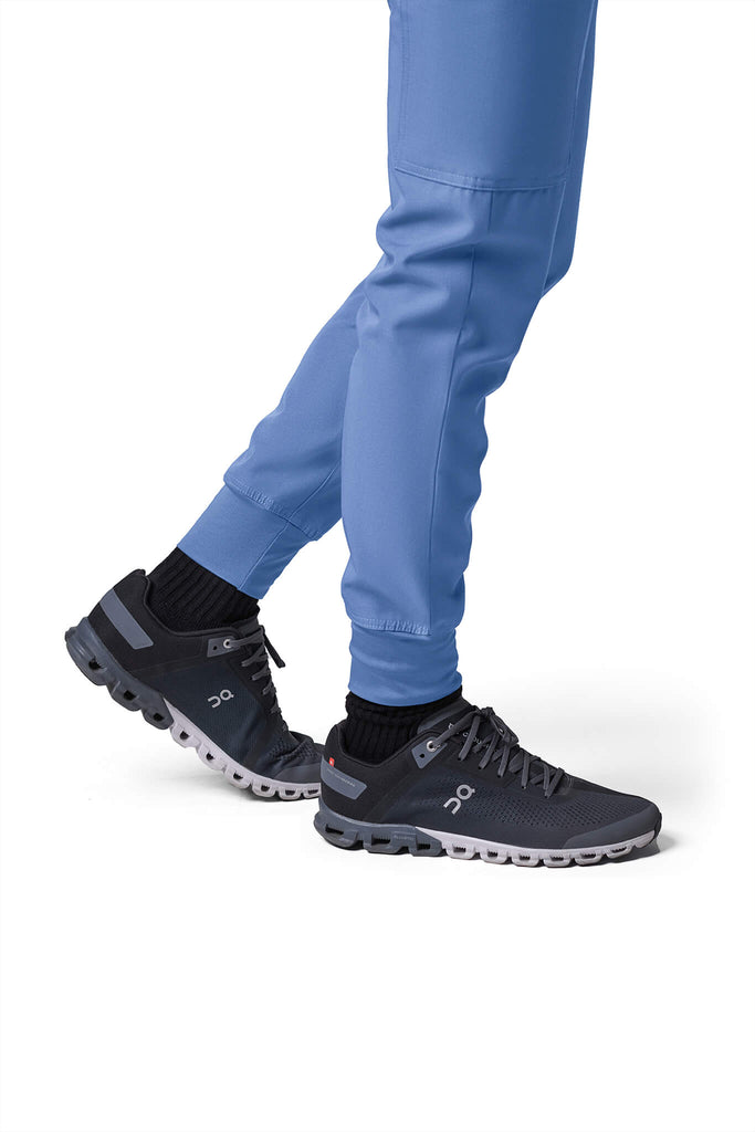 Man wearing MedTailor men's custom scrub pants in Sky Blue color fabric