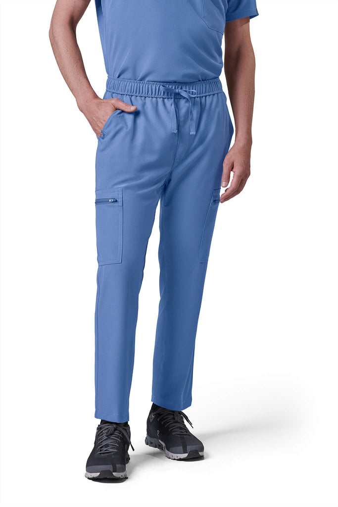Man wearing MedTailor men's custom scrub pants in Sky Blue color fabric