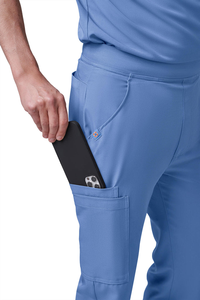 Man wearing MedTailor men's custom scrub pants in Sky Blue color fabric