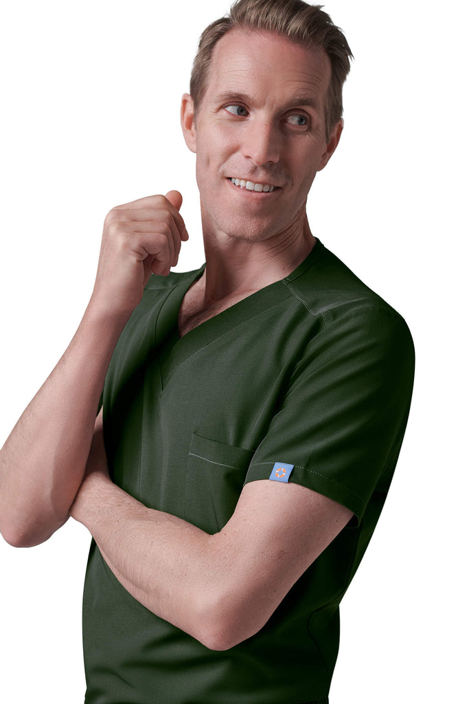 Man wearing MedTailor men's custom scrub top in Highland Green color fabric