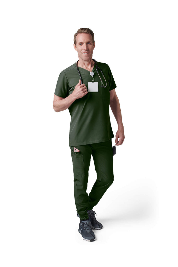 Man wearing MedTailor men's custom scrub top in Highland Green color fabric