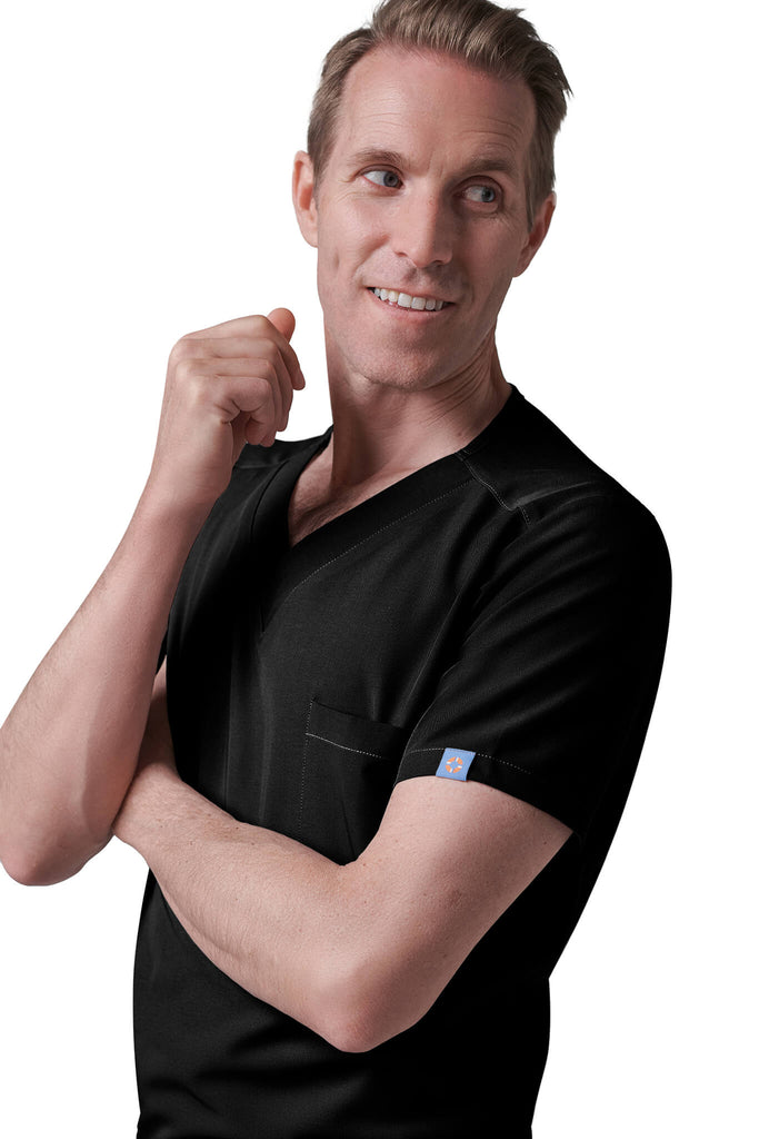 Man wearing MedTailor men's custom scrub top in Jet Black color fabric