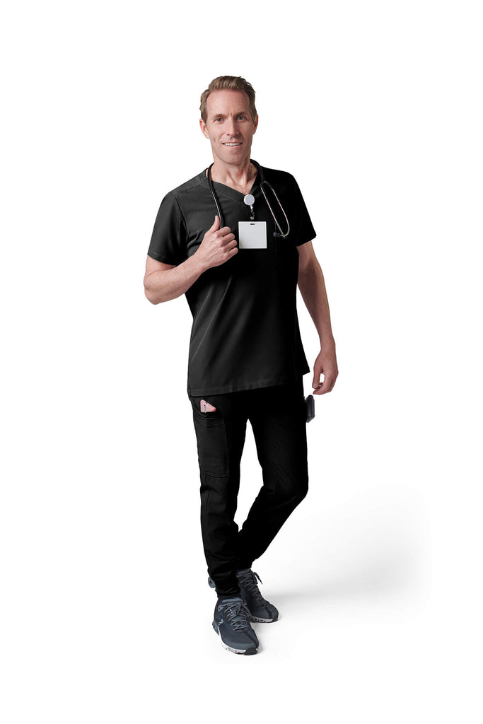 Man wearing MedTailor men's custom scrub top in Jet Black color fabric