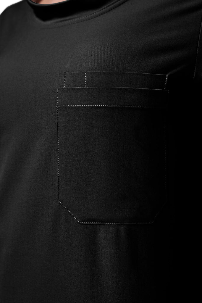 Man wearing MedTailor men's custom custom scrub top in Jet Black color fabric