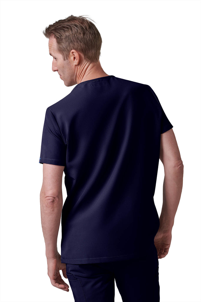 Man wearing MedTailor men's custom scrub top in Navy Blue color fabric