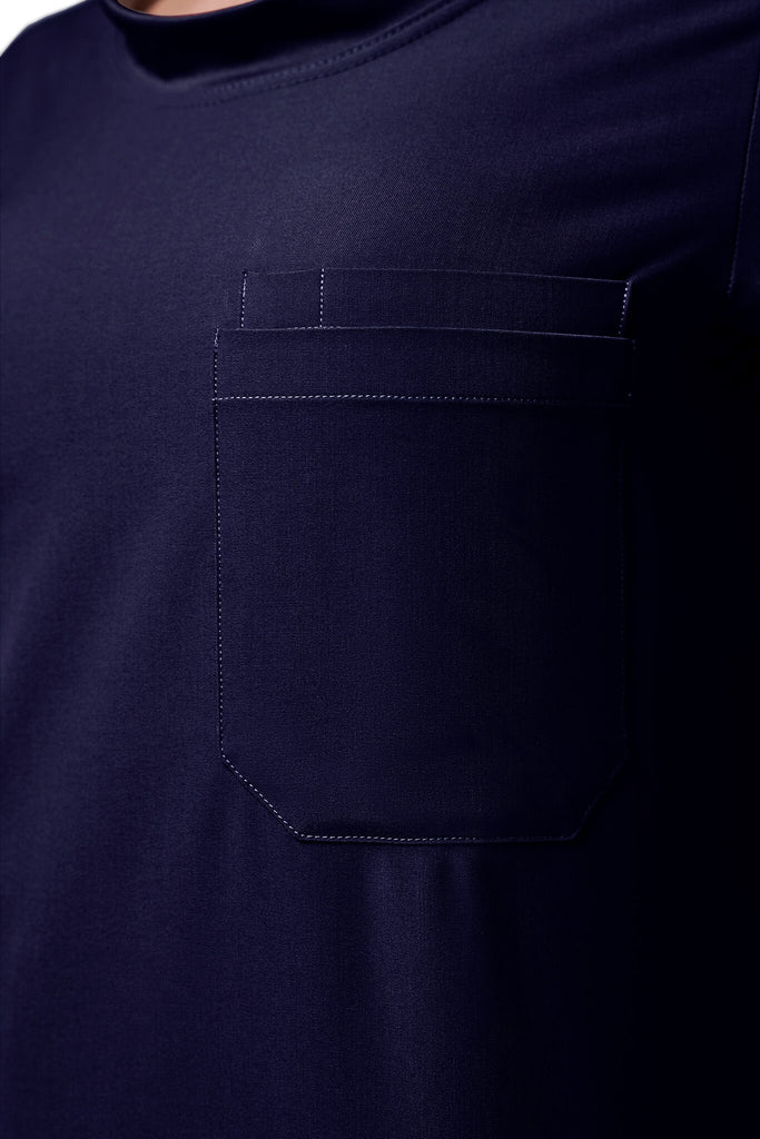 Man wearing MedTailor men's custom scrub top in Navy Blue color fabric