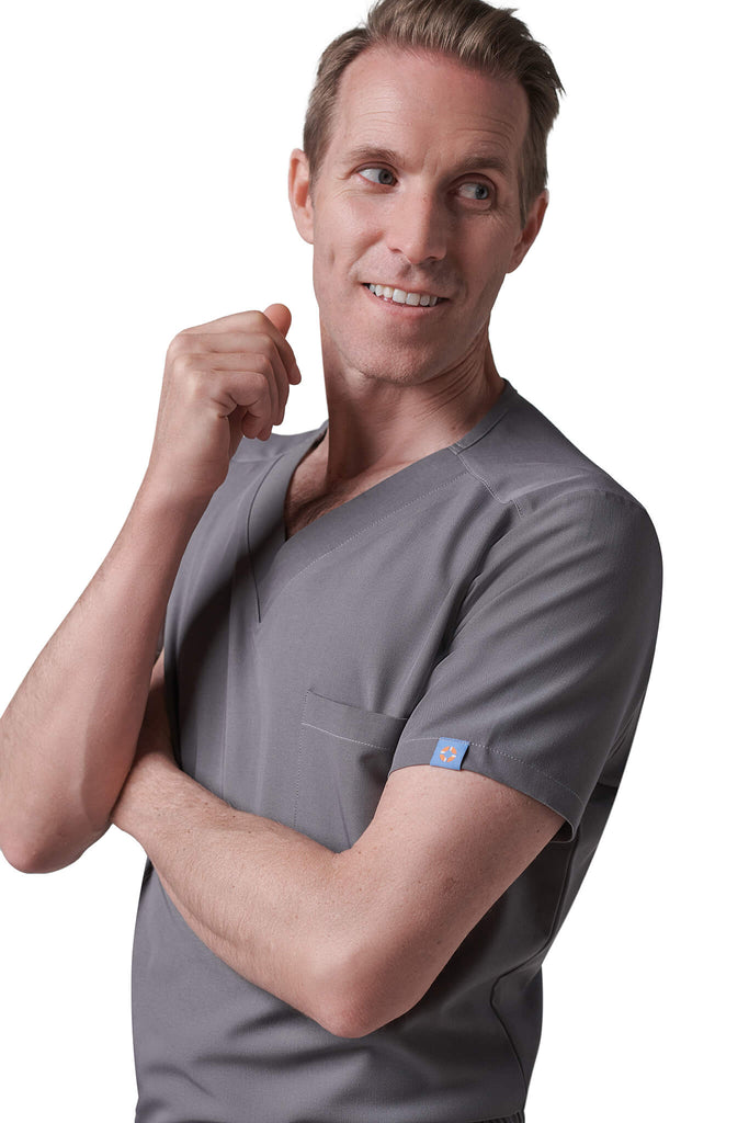 Man wearing MedTailor men's custom scrub top in Platinum Gray color fabric