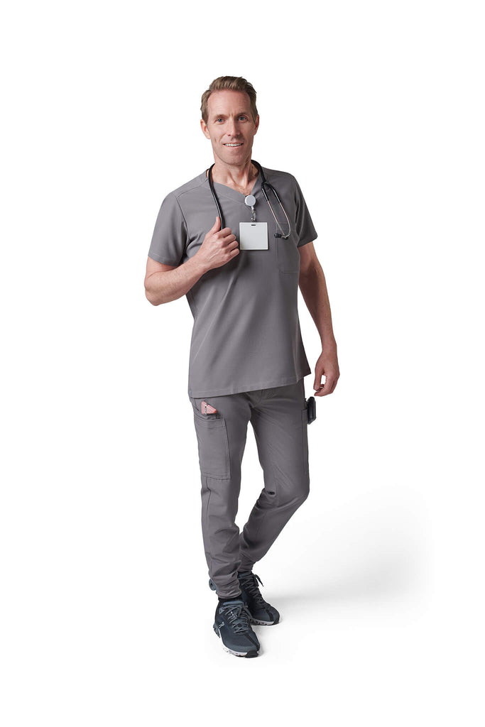Man wearing MedTailor men's custom scrub top in Platinum Gray color fabric