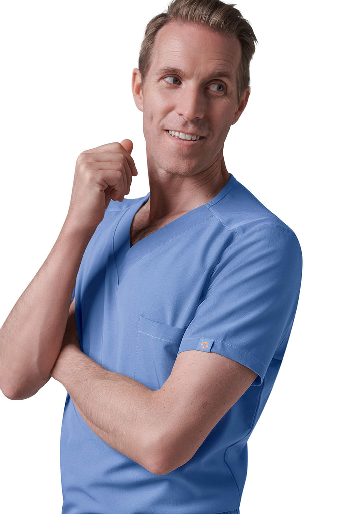 Man wearing MedTailor men's scrub top in Sky Blue color fabric