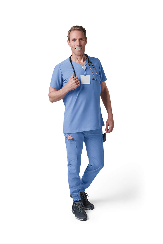 Man wearing MedTailor men's custom scrub top in Sky Blue color fabric