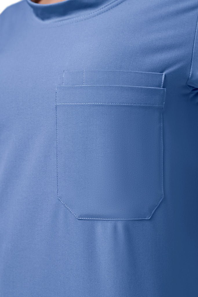 Man wearing MedTailor men's custom scrub top in Sky Blue color fabric