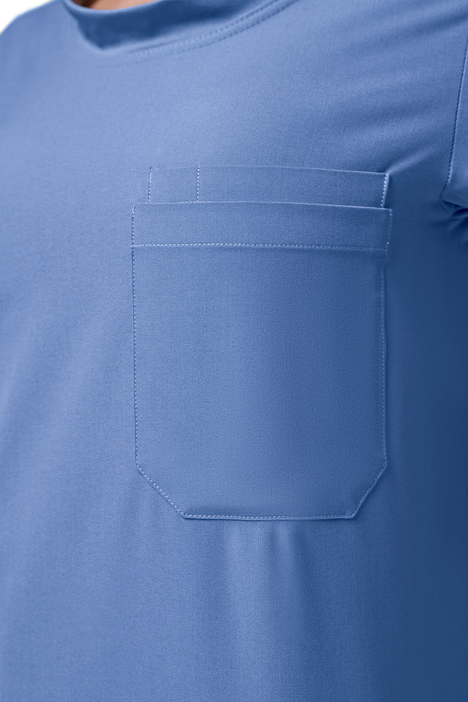 Man wearing MedTailor men's scrub top in Sky Blue color fabric