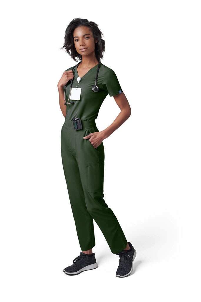Woman wearing MedTailor women's scrub pants in Highland Green color fabric