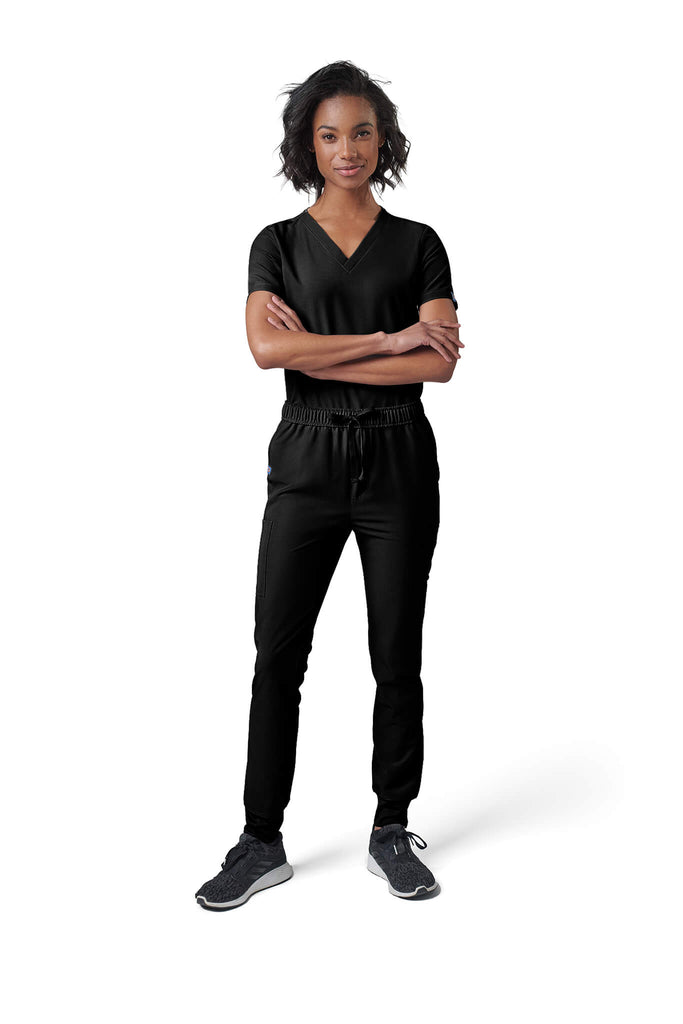 Woman wearing MedTailor women's scrub pants in Jet Black color fabric