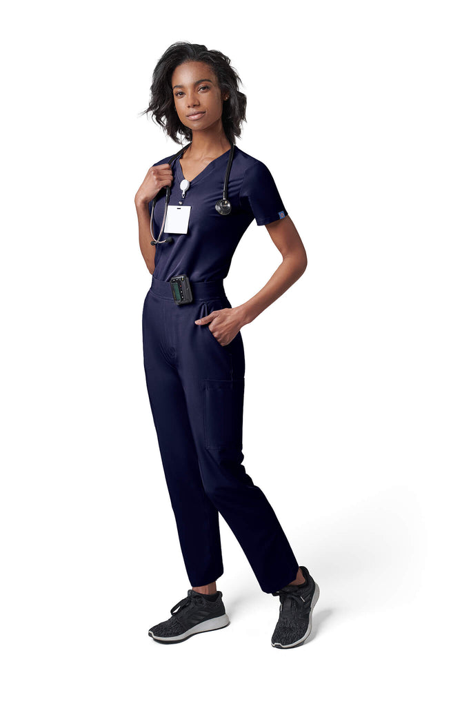 Woman wearing MedTailor women's scrub pants in Navy Blue color fabric