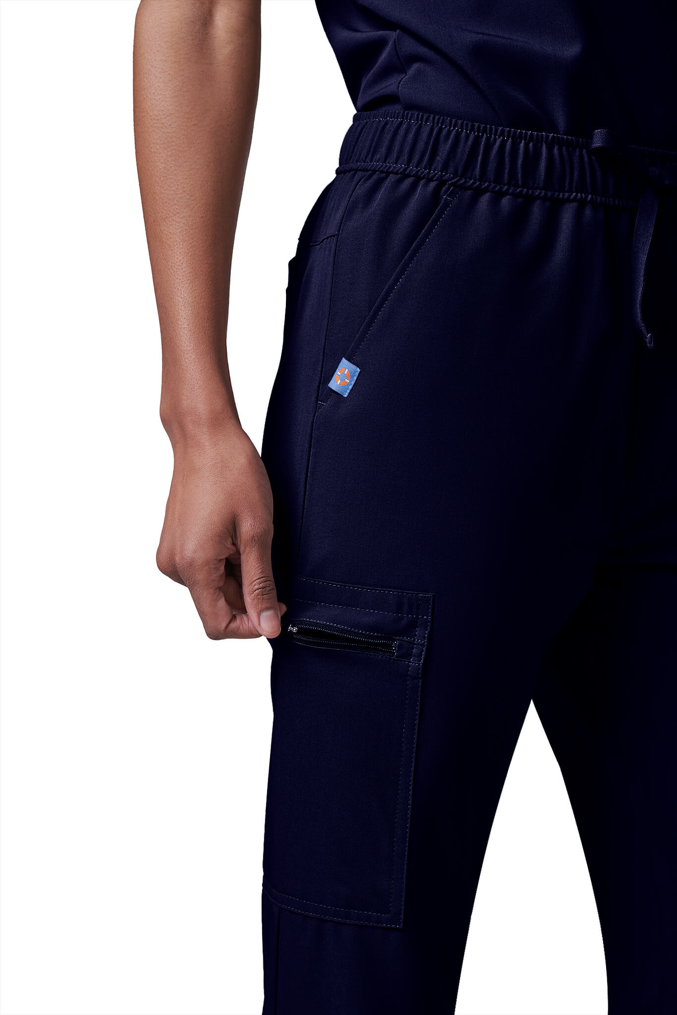 Woman wearing MedTailor women's custom scrub pants in Navy Blue color fabric