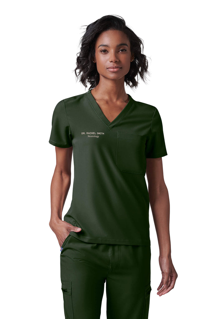 Woman wearing MedTailor women's scrub top in Highland Green color fabric