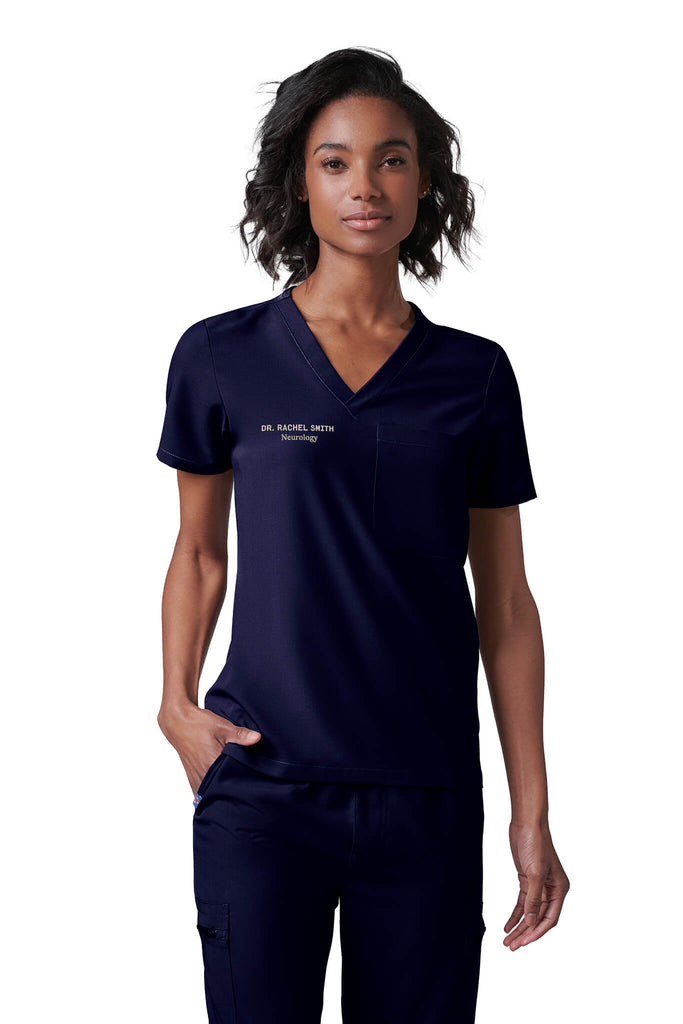 Woman wearing MedTailor women's scrub top in Navy Blue color fabric