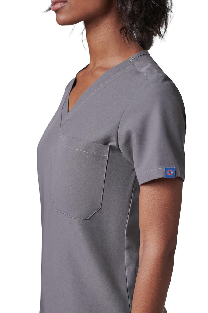 Woman wearing MedTailor women's scrub top in Platinum Gray color fabric